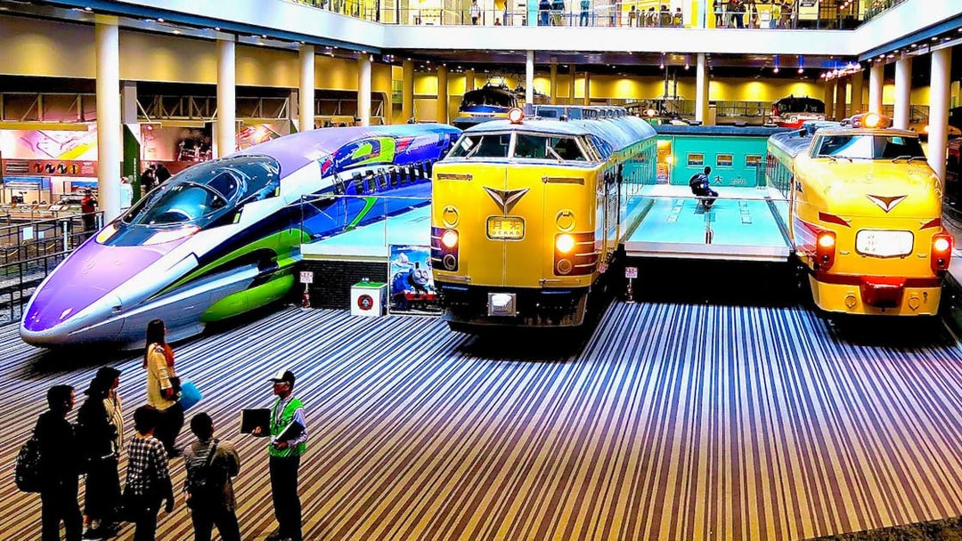 Kyoto Railway Museum trains display with visitors exploring exhibits.