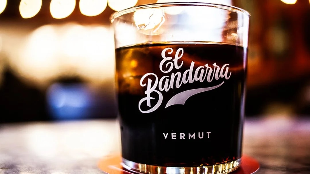 Glass of El Bandarra vermut on a table during La Barceloneta food tour.
