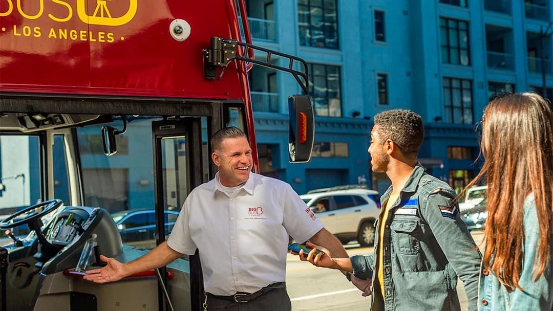 Tourists boarding a Los Angeles double-decker bus for the Hop-On Hop-Off Tour near Hollywood Walk of Fame.