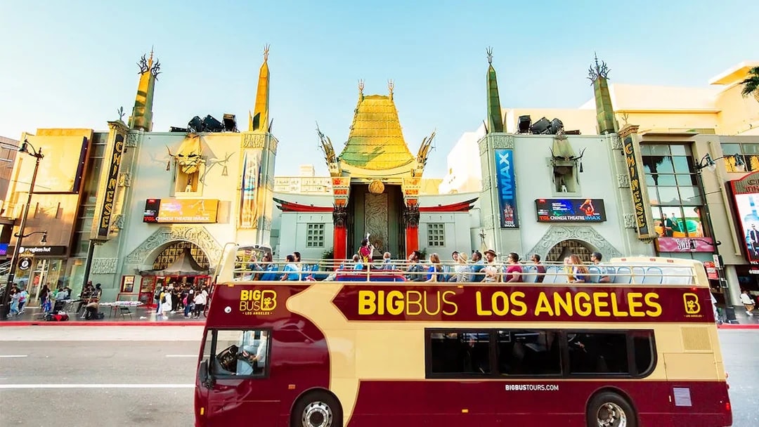 Tourists on Los Angeles Hop-On Hop-Off bus in front of TCL Chinese Theatre.