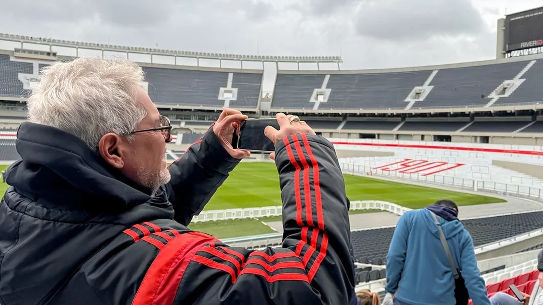 Tourist taking photos at La Bombonera stadium in Buenos Aires.