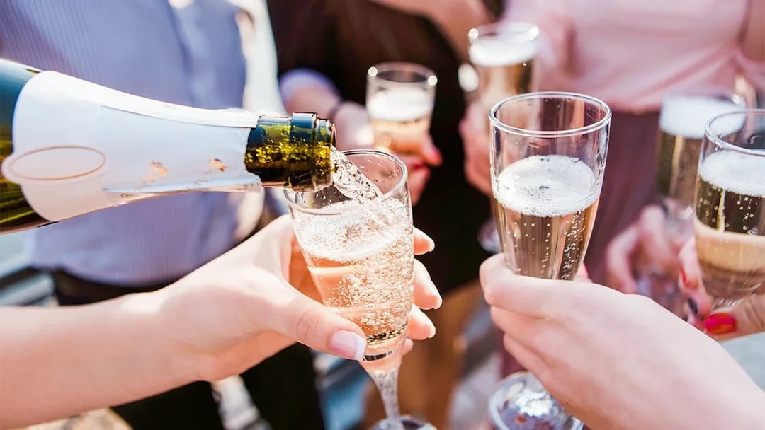 Pouring champagne into glasses at Cabaret La Nouvelle Eve spectacle.