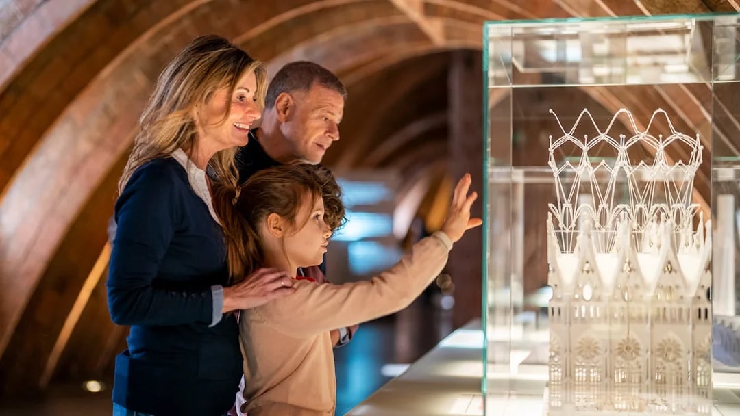 Visitors observing architectural model at La Pedrera-Casa Milà, Barcelona.