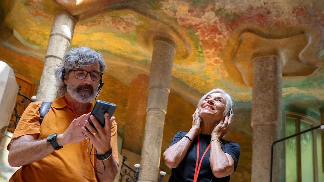 Visitors enjoying an audio tour at La Pedrera, Barcelona.