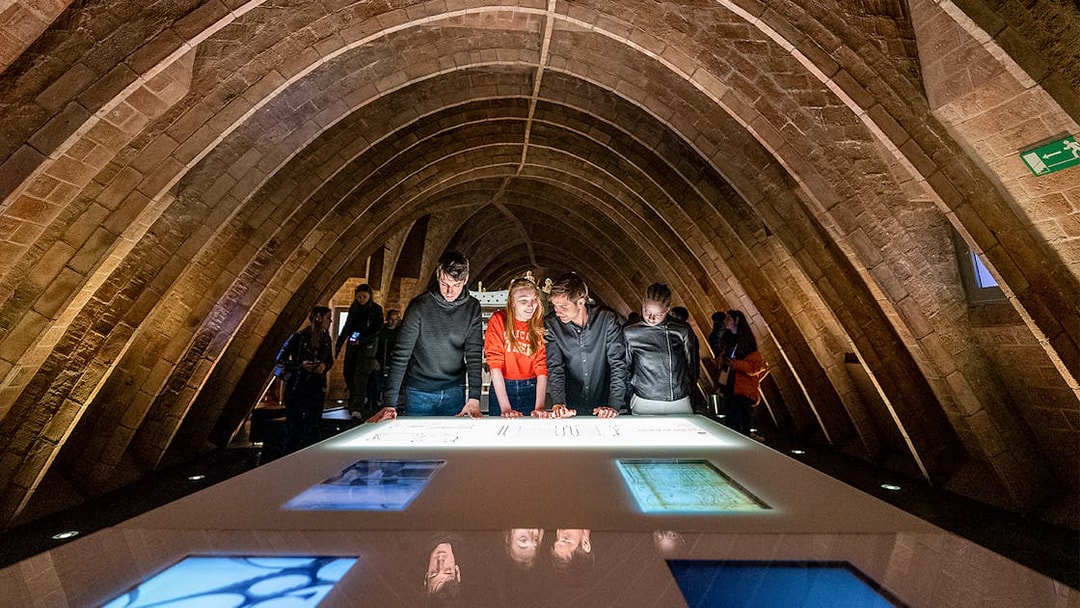 Visitors exploring exhibits at La Pedrera Sunrise Tour, Casa Milà, Barcelona.