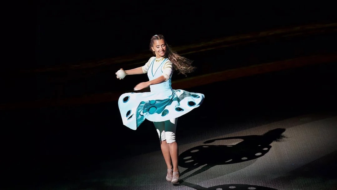 Performer spinning on stage at La Perle by Dragone show in Dubai.