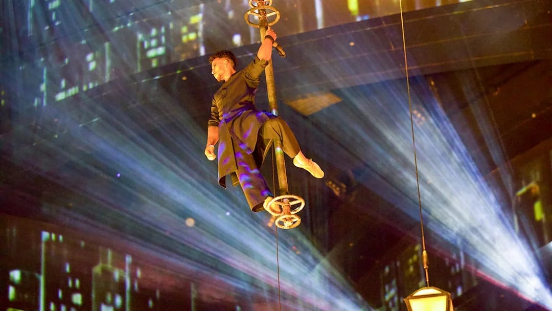Performer suspended in air during La Perle by Dragone show in Dubai.