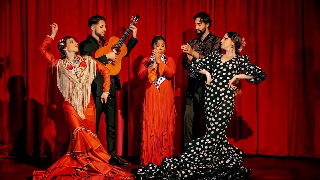 Flamenco dancers and guitarist performing on stage at Laietana, Barcelona.
