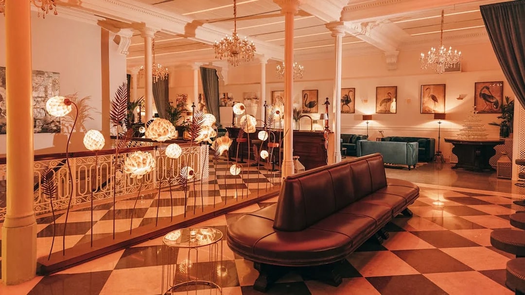 Elegant interior of a Barcelona venue with chandeliers and art, suitable for flamenco performances.