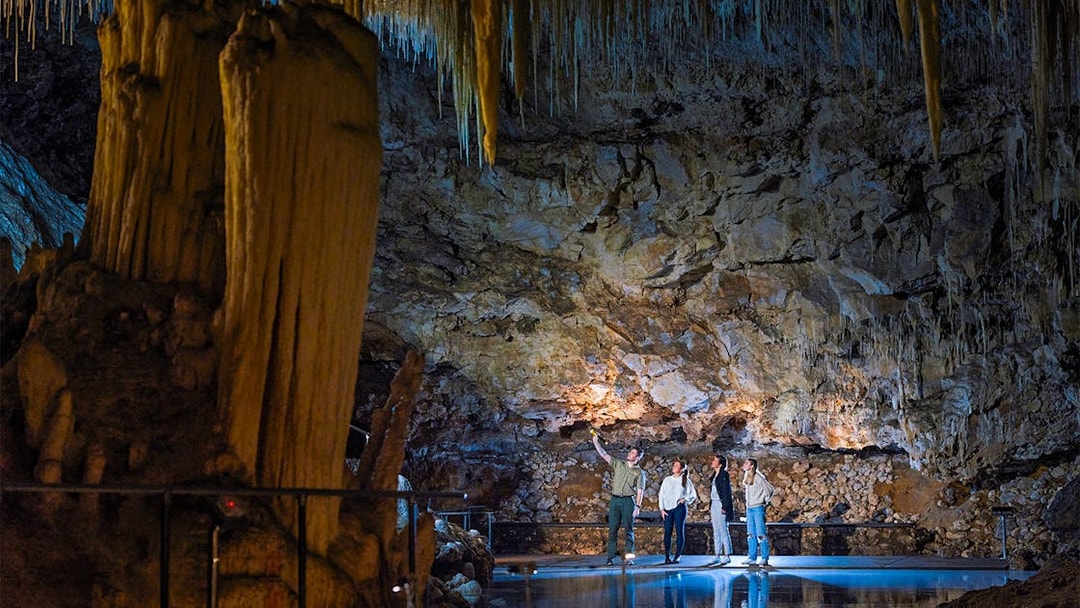 Guide explains cave formations to visitors in Lake Cave, Margaret River.