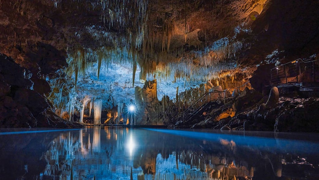 Illuminated stalactites and reflections in Lake Cave, Margaret River.