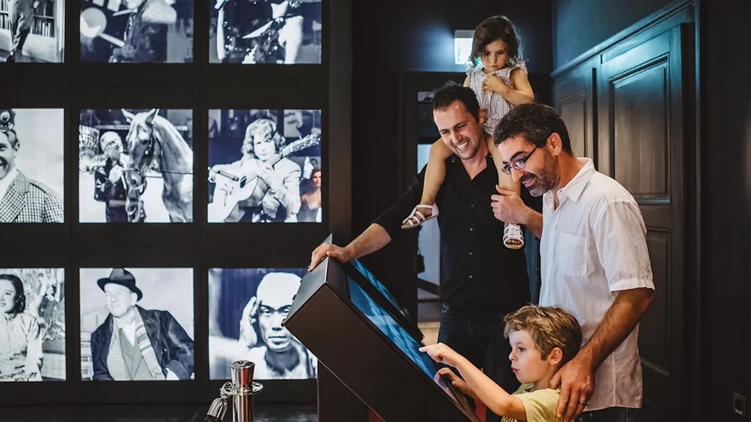 Visitors interacting with an exhibit at Chaplin’s World, Lake Geneva tour.