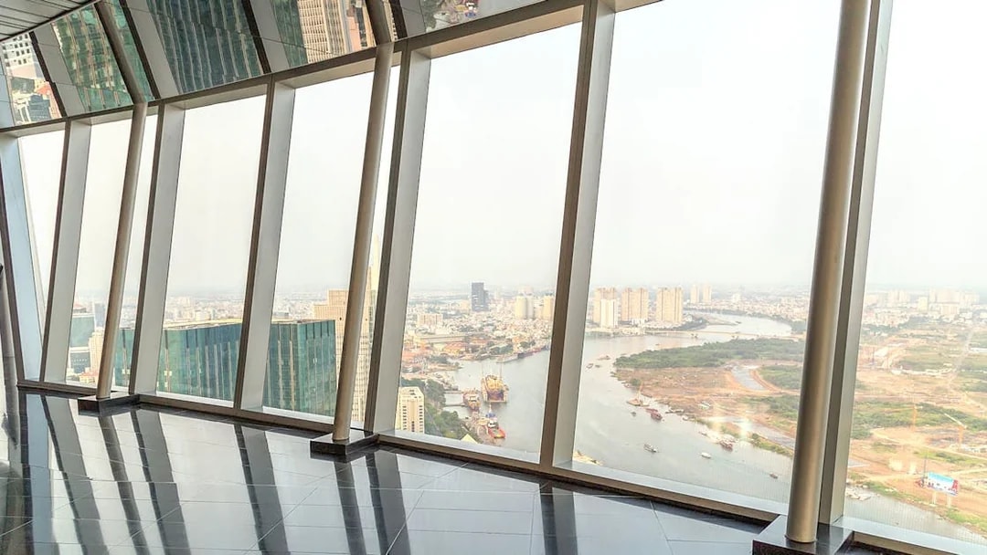 Panoramic view from sky deck in downtown Ho Chi Minh City, Vietnam, overlooking river and cityscape.