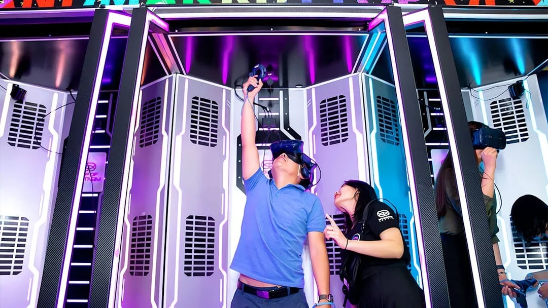 Visitors experiencing virtual reality at Landmark 81, using VR headsets in a futuristic setting.