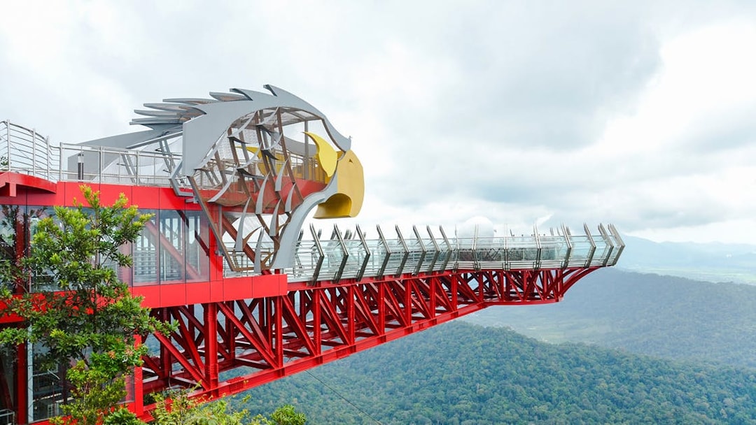 Langkawi Skywalk with eagle-themed structure overlooking lush green forest.