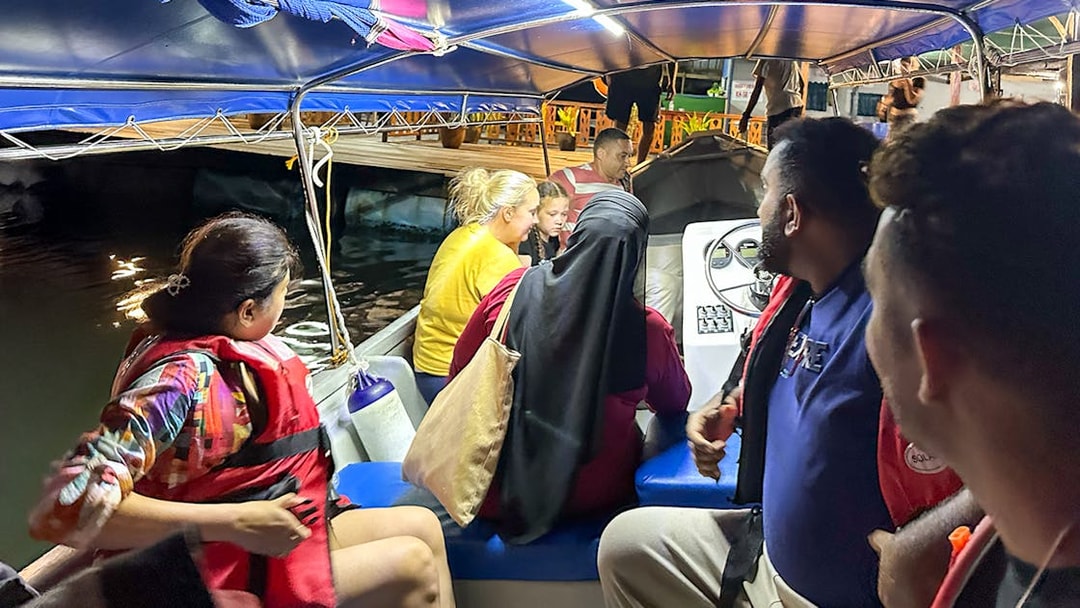 Passengers on a night tour boat during Langkawi mangrove excursion.