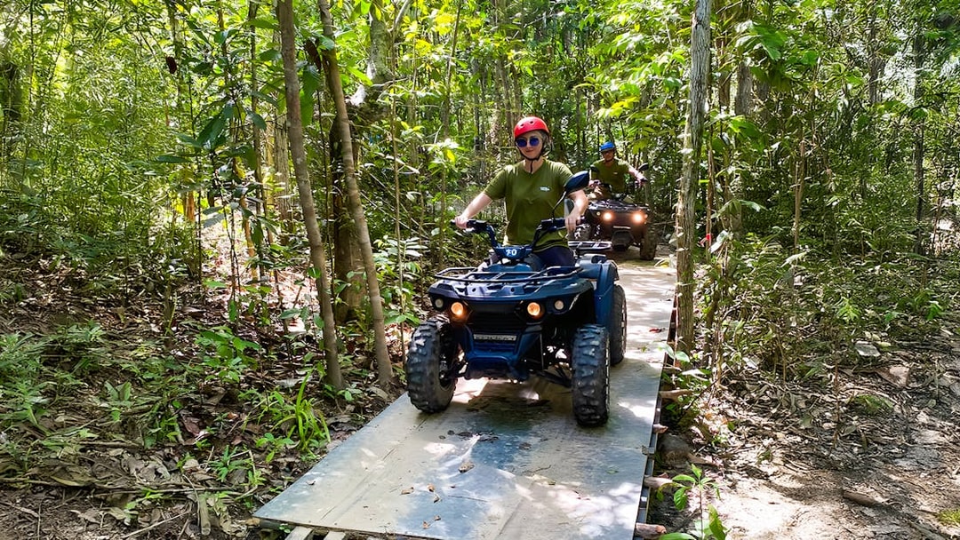 ATV riders navigating forest trail on Langkawi Sky ATV Ride, Mountain Manchinchang.
