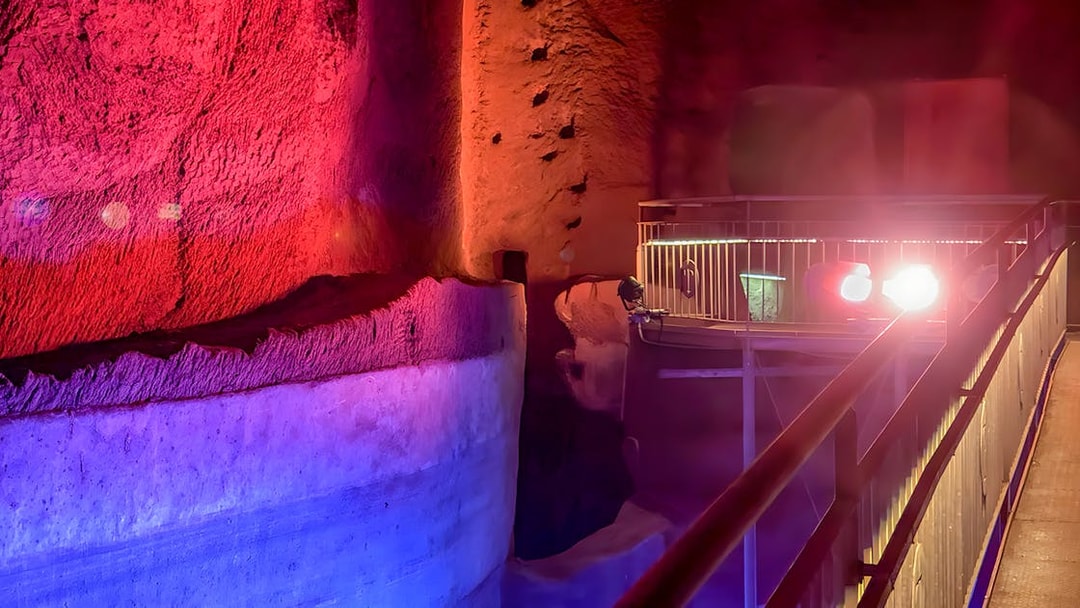 Underground passage with colorful lighting at LAPIS Museum, Naples.