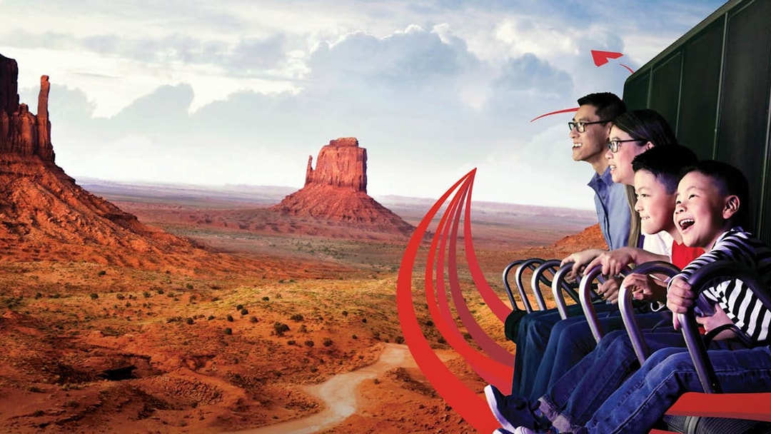 Family enjoying a virtual ride over Monument Valley with Go City: Las Vegas Explorer.