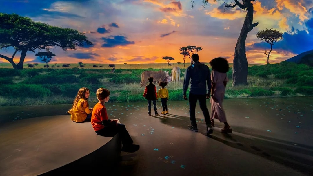 Family viewing immersive savanna exhibit at Las Vegas attraction.