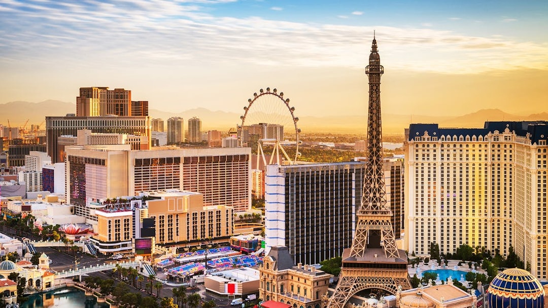 Las Vegas skyline with Eiffel Tower replica and High Roller observation wheel.