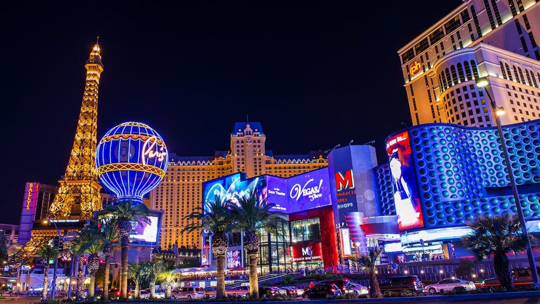 Las Vegas Strip at night with Paris Hotel and Eiffel Tower replica.