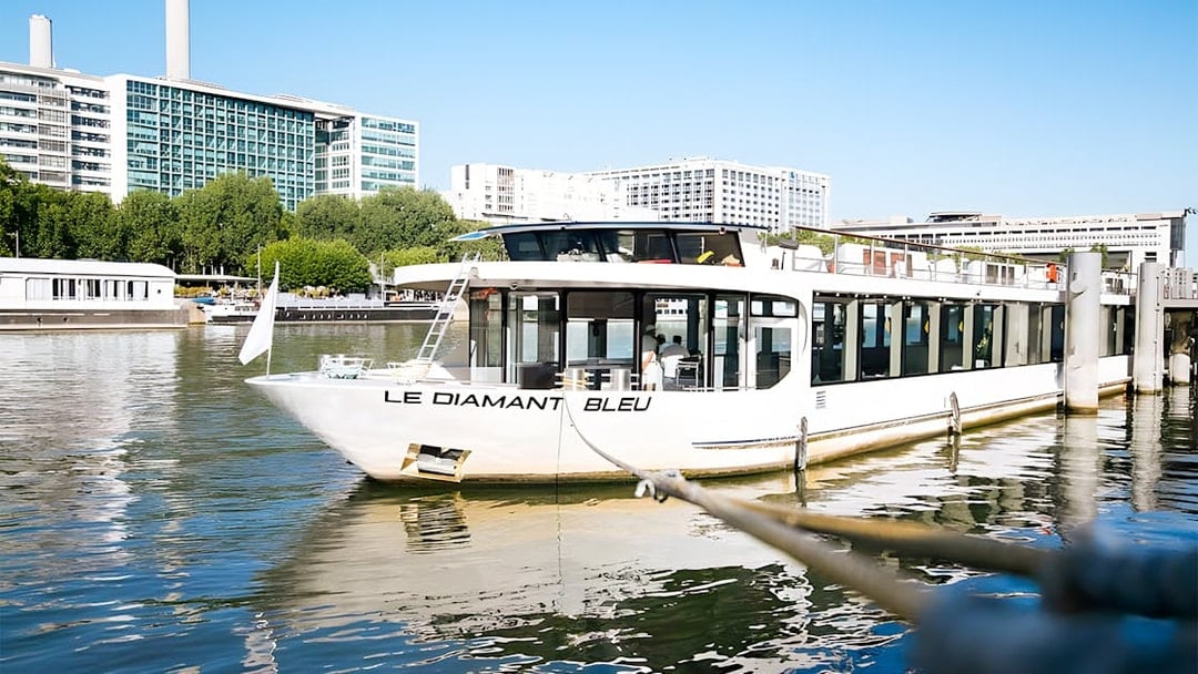 Le Diamant Bleu cruise ship docked on the Seine River in Paris.
