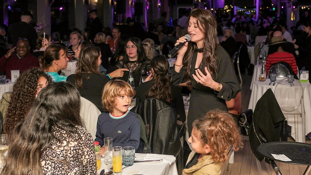 Singer performing for guests on Le Diamant Bleu Seine River dinner cruise.