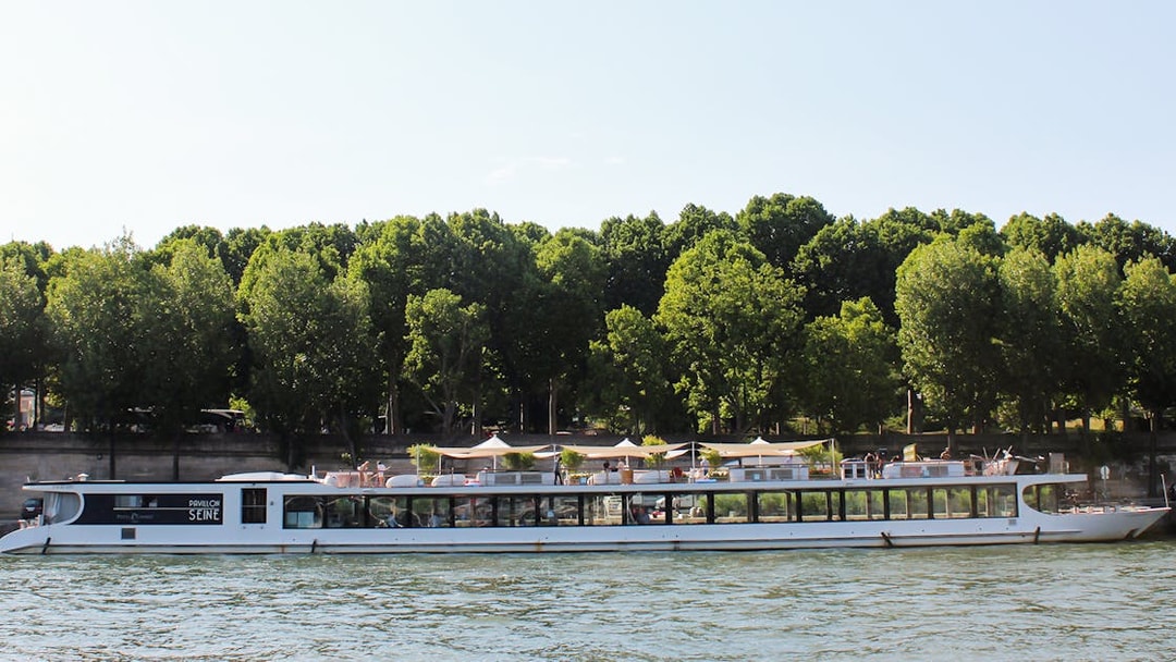 Seine River cruise boat with dining area, Paris.