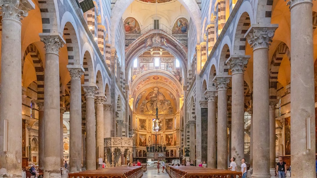 Pisa Cathedral interior with ornate columns and detailed frescoes.