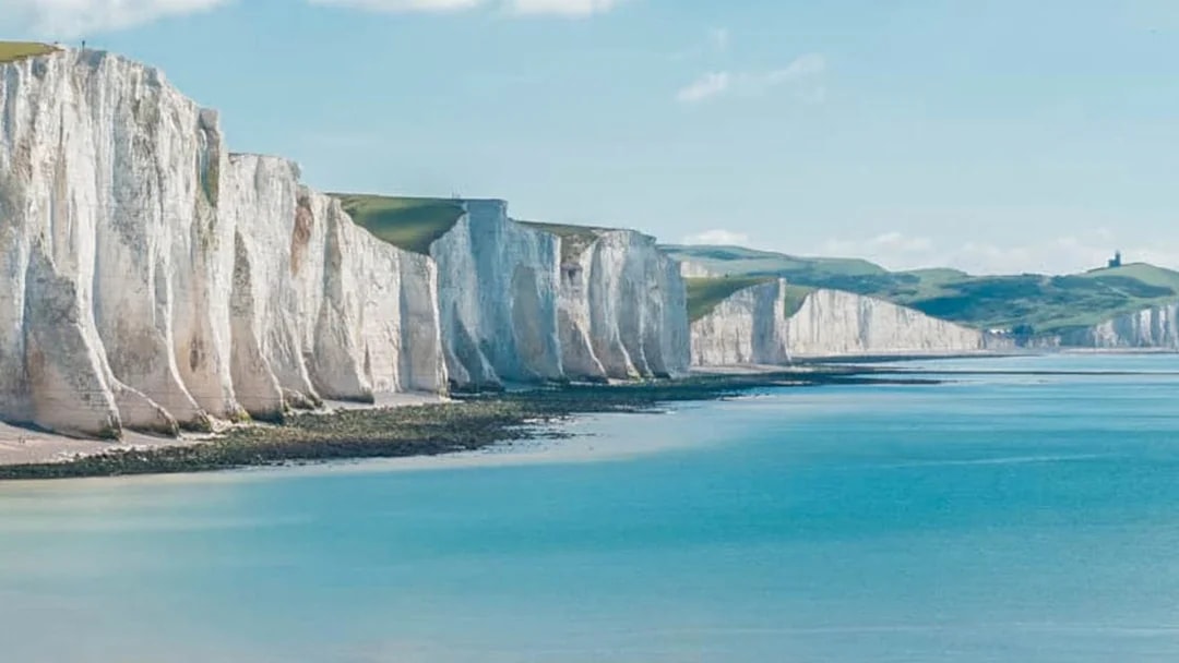 White Cliffs of Dover along the coastline under a clear sky.