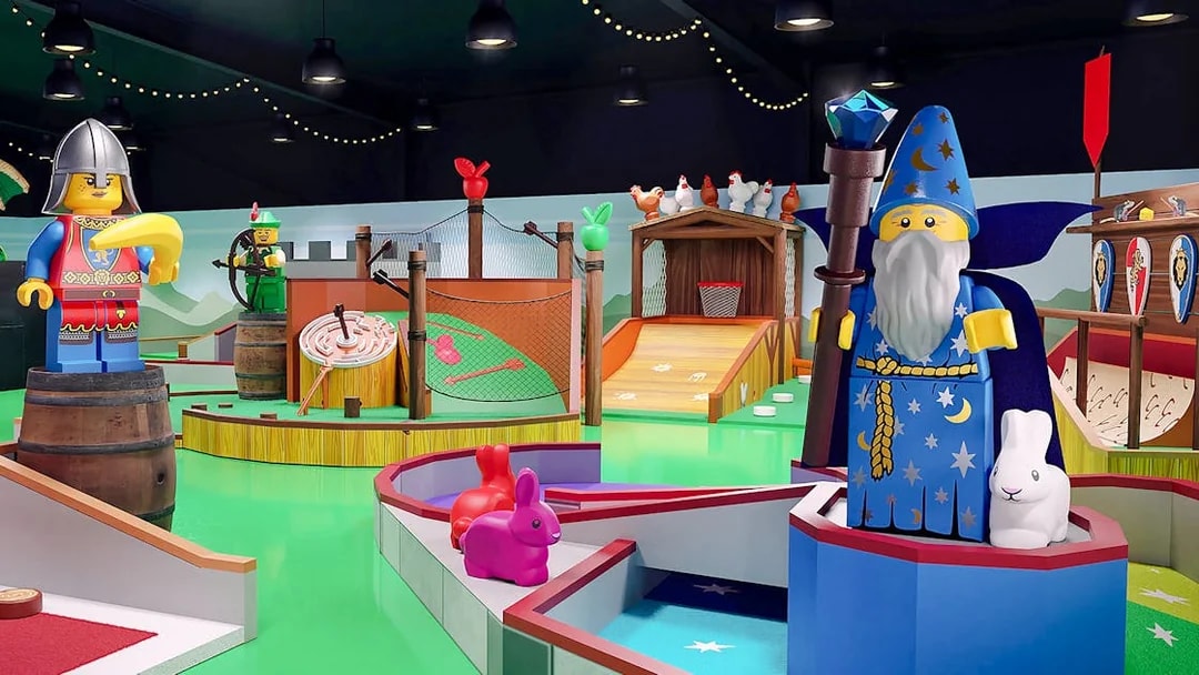 Medieval-themed mini golf course at LEGOLAND® Adventure Golf with wizard and knight LEGO figures.