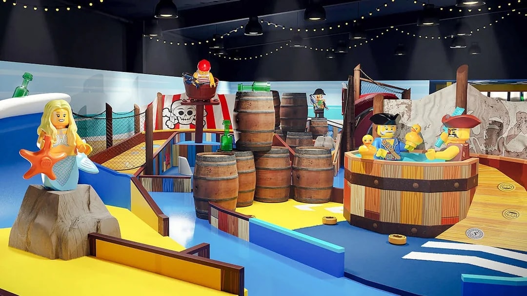 LEGOLAND® Adventure Golf pirate-themed mini golf course with LEGO figures and barrels.