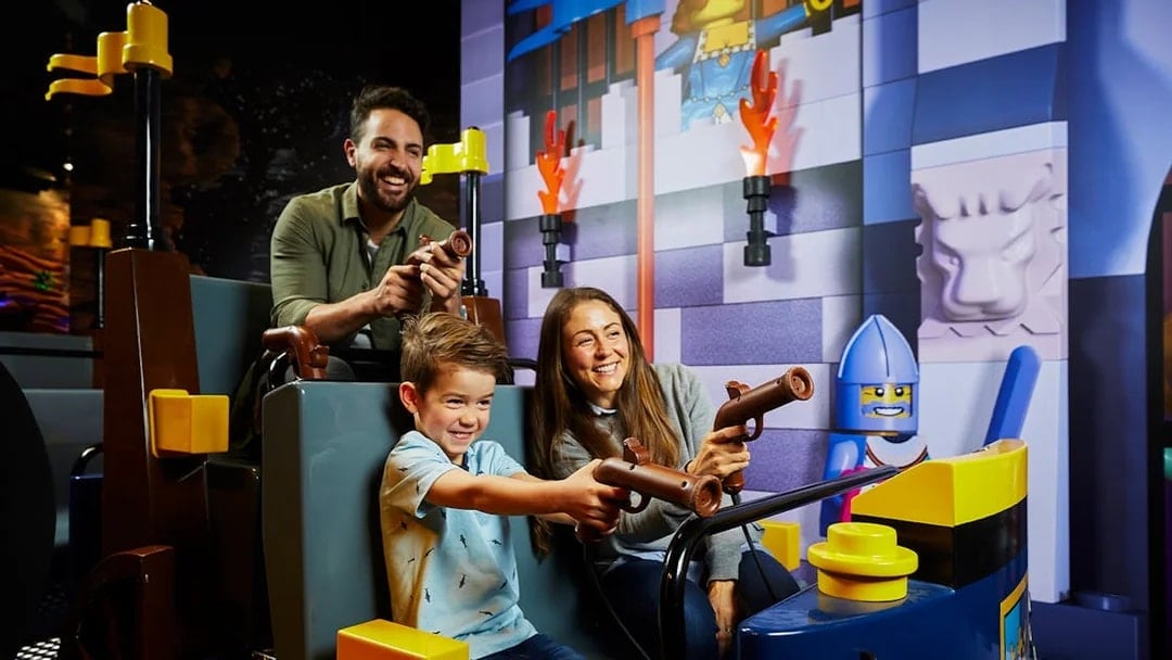 Family enjoying interactive ride at LEGOLAND Discovery Centre.