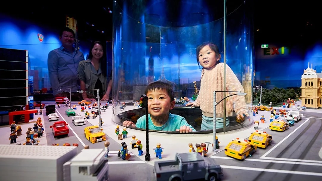 Children exploring LEGO city display at LEGOLAND Discovery Centre.