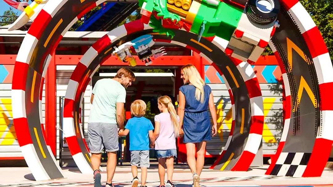 Family walking through colorful arch at LEGOLAND Deutschland.