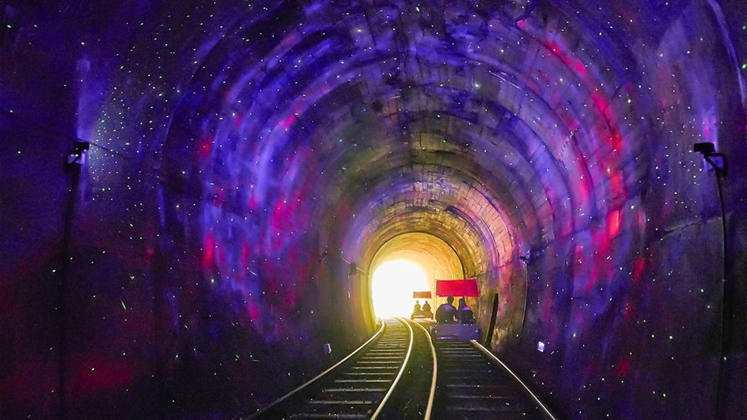 Railbike ride through illuminated tunnel on Gangchon Railbike Day Tour, Korea.