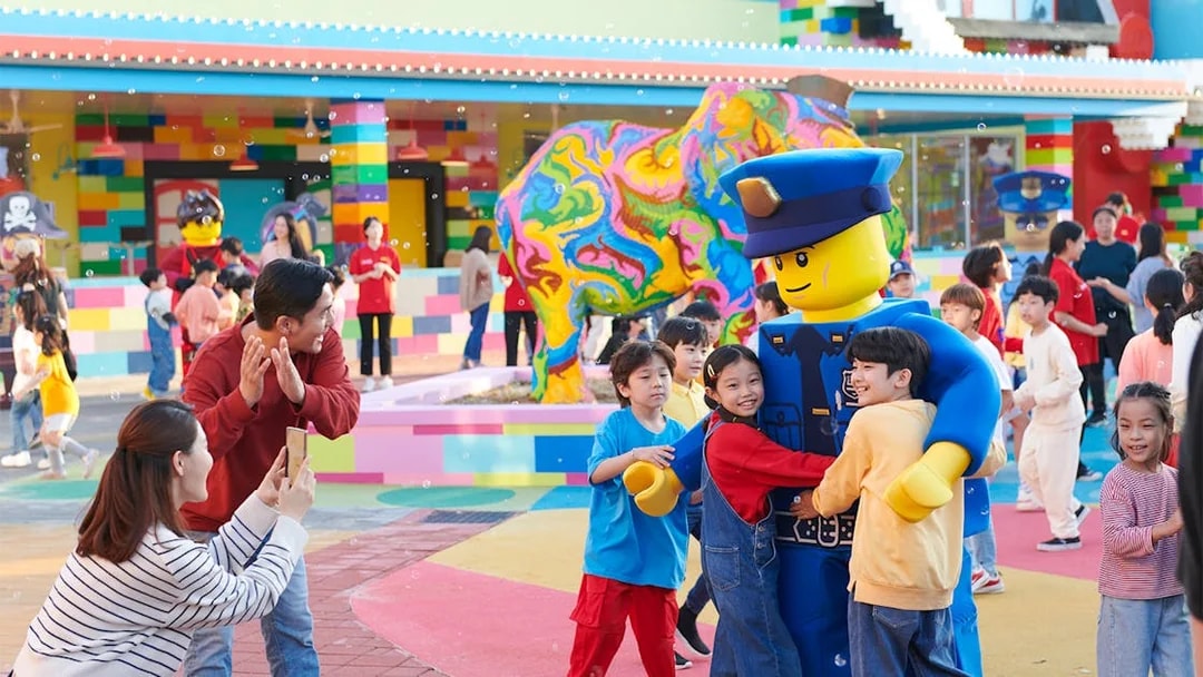 Children hugging a Lego character at Legoland Korea.