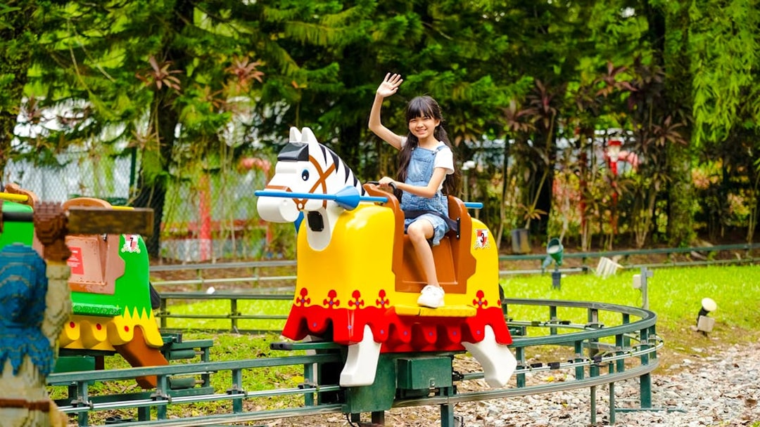 Child enjoying a ride at Lego Kingdoms in Legoland Malaysia.