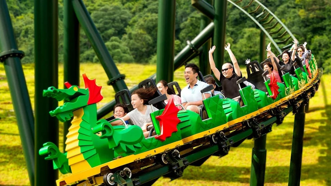 Family riding the Dragon roller coaster at Legoland Theme Park, Malaysia.