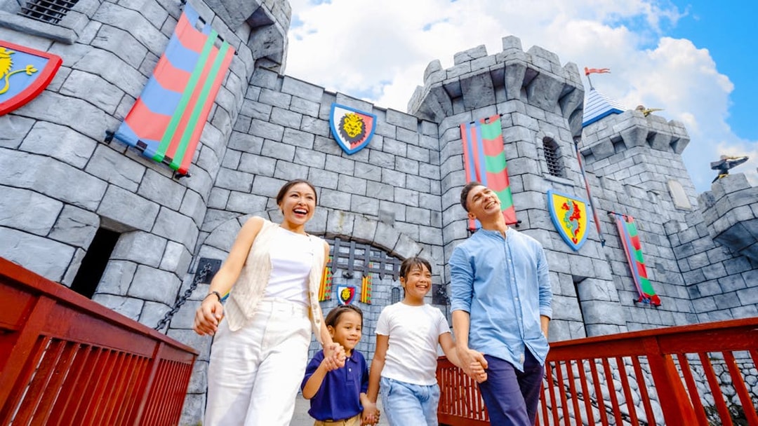 Family walking near castle at LEGOLAND Malaysia Theme Park.