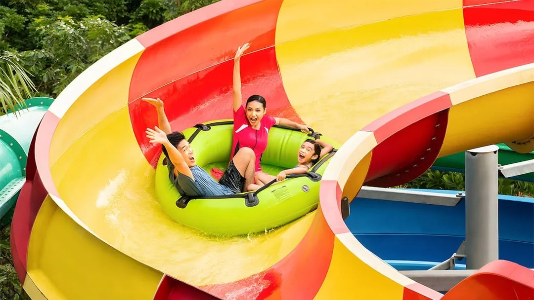 Family enjoying a water slide at LEGOLAND Malaysia Water Park.