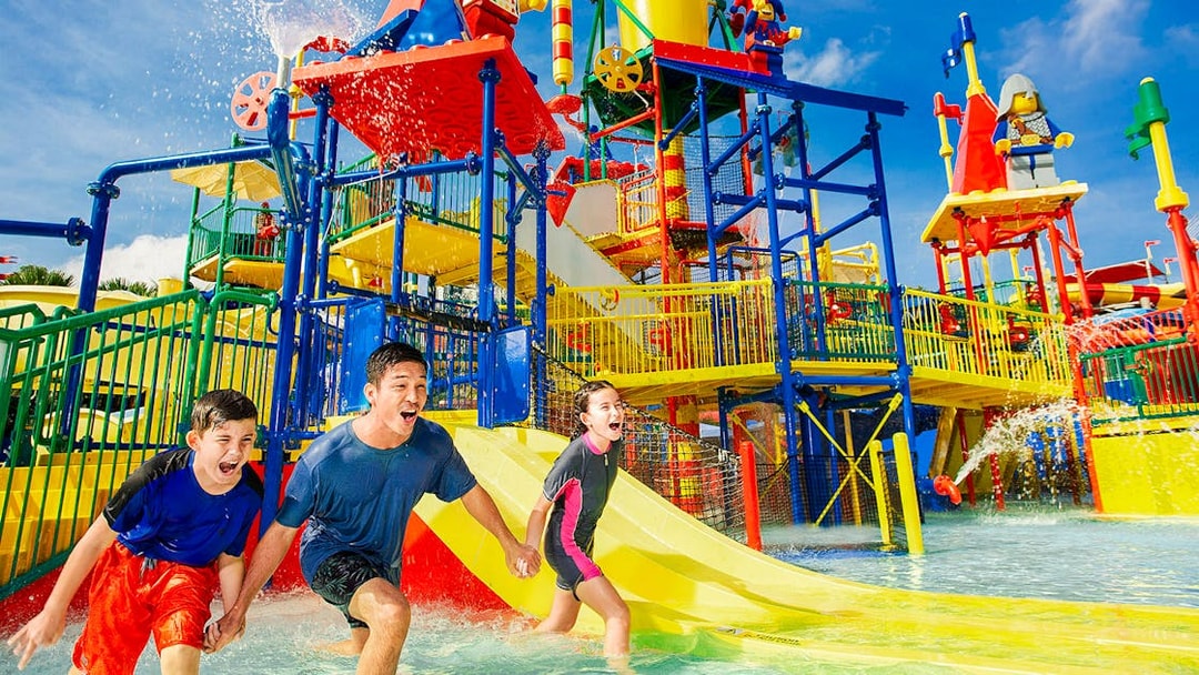Family enjoying Joker ride at Legoland Malaysia water park.