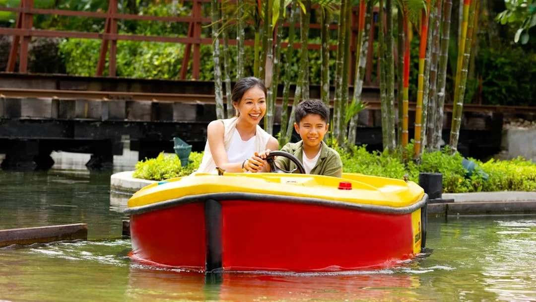 Family enjoying a boat ride at Legoland Malaysia.