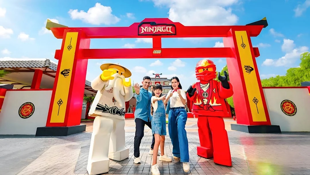 Family posing with Lego Ninjago figures at LEGOLAND Malaysia Theme Park.