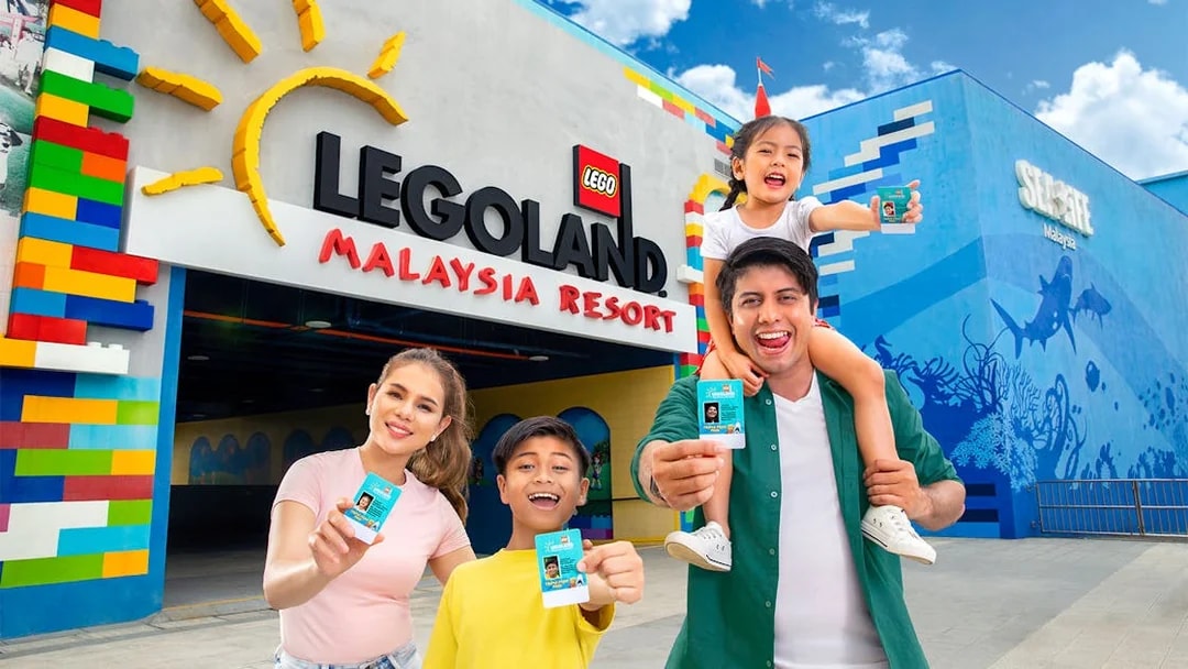 Family holding day passes at LEGOLAND Malaysia entrance.