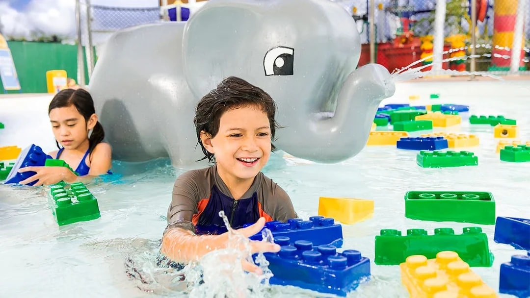 Children playing with LEGO bricks in water at LEGOLAND Malaysia Water Park.