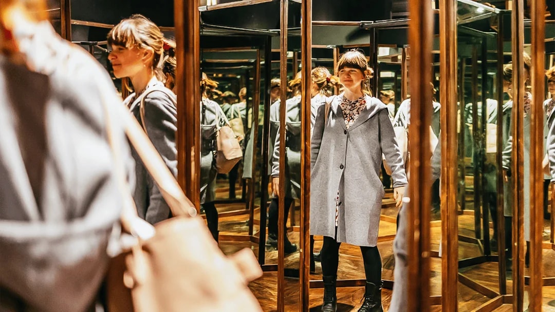 Visitor exploring mirror room at Leonardo Interactive Museum, Florence.