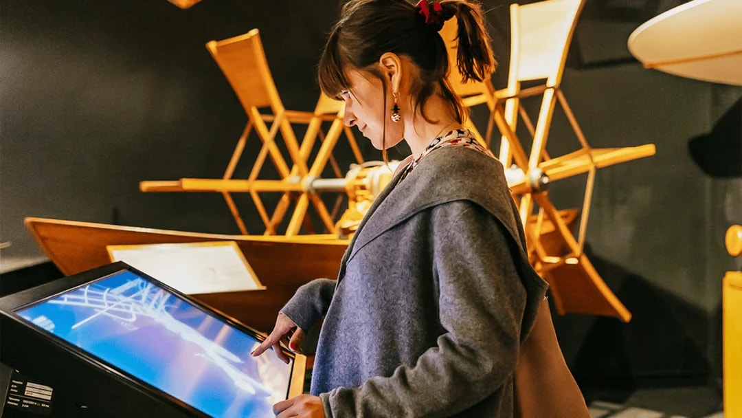 Visitor interacting with a touchscreen at Leonardo Interactive Museum, Florence.