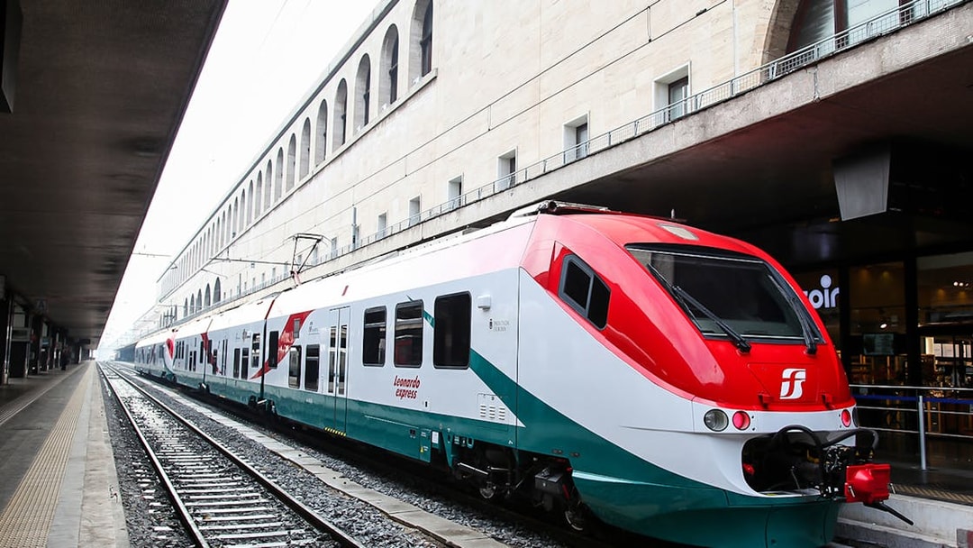 Leonardo Express train at Rome Termini Station platform, connecting to Fiumicino Airport.